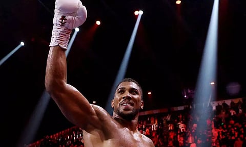 Anthony Joshua celebrates after winning his fight against Otto Wallin (Reuters)
