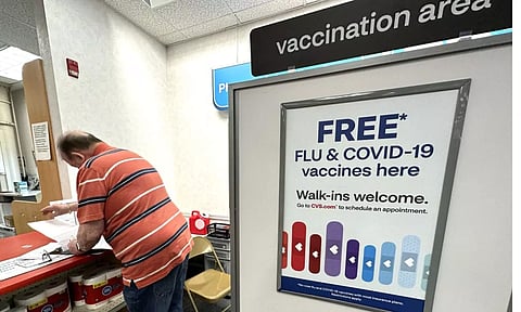 &nbsp;A sign for flu and covid vaccinations is displayed at a pharmacy store in Palatine, Ill