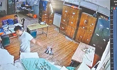 A video grab of head constable taking a bunch of seized gutkha sachets stored at Otteri police station