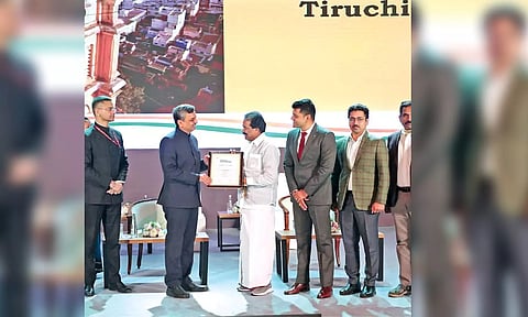 Tiruchy Mayor M Anbazhagan receiving the award in New Delhi on Thursday as City Commissioner R Vaithinathan and others look on