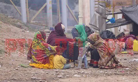 &nbsp;People sit near an earthen stove to warm themselves during a cold winter morning, in Jammu, Saturday. (PTI)