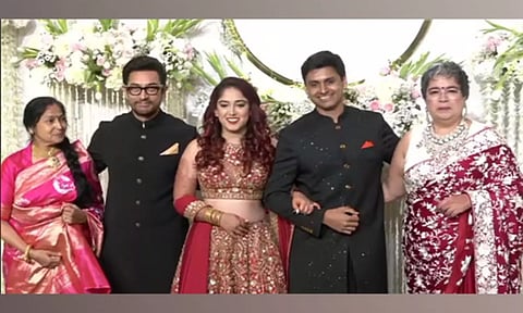 Aamir Khan poses with newlyweds Ira Khan, Nupur Shikhare at wedding reception