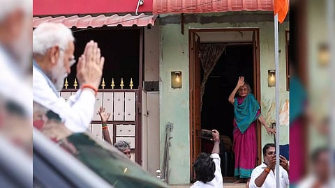 Prime Minister Narendra Modi greets an elderly woman during roadshow ahead of temple visit in Tamil Nadu (Photo/ANI)