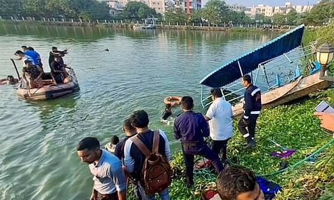 People gather during a rescue and search operation after a boat overturned in a lake, in Vadodara on January 18, 2024. (PTI)