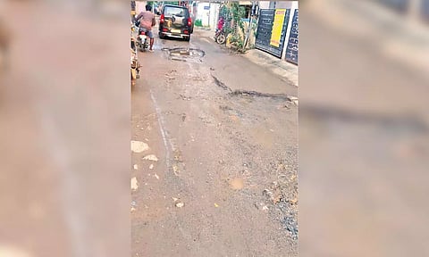 A damaged road at Bharath Nagar in Kolathur