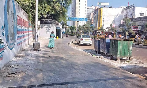 The pavement where people urinate and the waste bin near to it raise a stink