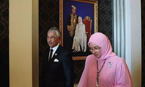 Malaysia's King Al-Sultan Abdullah Sultan Ahmad Shah and Queen Tunku Azizah Aminah Maimunah Iskandariah walk holding hands after an interview with the media at National Palace, in Kuala Lumpur. (Reuters)