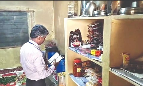 An official of the Food Safety Department inspects the college kitchen on Friday