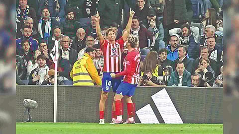 Atletico’s Marcos Llorente celebrates after scoring in the 90+3 min’ against Real Madrid