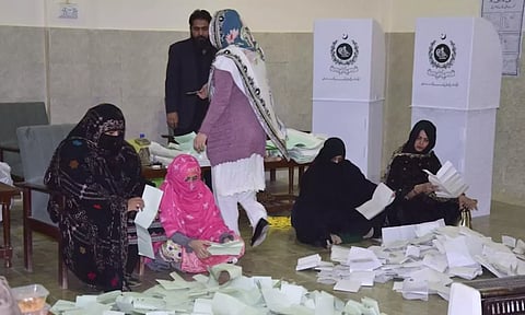 Members of polling staff start counting the votes following polls closed for parliamentary elections, in Quetta, Pakistan | Photo: PTI