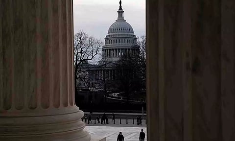 Tourists walk near the US Capitol as the Senate votes to begin work on a bill that includes aid for Ukraine, Israel, and Taiwan in Washington on February 9, 2024. (Reuters)