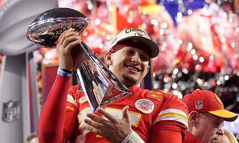Kansas City Chiefs quarterback Patrick Mahomes celebrates with the trophy after the team’s win in overtime during the NFL Super Bowl 58 football game against the San Francisco 49ers on Sunday, Feb. 11, 2024, in Las Vegas. The Chiefs won 25-22.&nbsp;