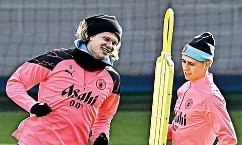 Erling Haaland (L) during a training session ahead of Champions League clash