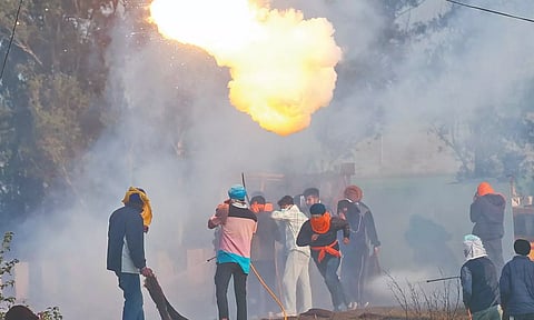 Farmers run for cover as police fire tear gas to disperse them at Shambhu border between Punjab and Haryana, on Wednesday