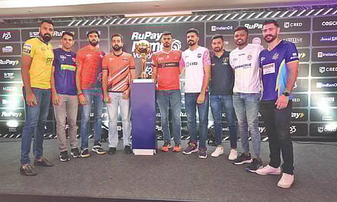 Captains of each team pose with the trophy