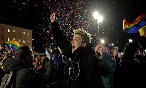 Same-sex couples celebrating after landmark decision by Greek Parliament (Reuters)