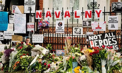 Flowers and tributes are left opposite the Russian embassy to commemorate Alexei Navalny's demise in London. (AP)