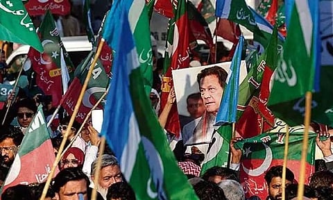 Supporters of the PTI political party outside a provincial election commission office during a protest in Karachi, Pakistan.