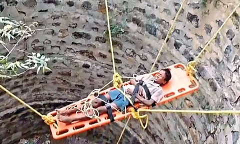 The boy being lifted from the well in Ariyalur