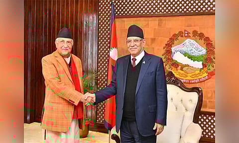 CPN-UML Chairman KP Sharma Oli (Left) and Nepal PM Pushpa Kamal Dahal (Right) shake hands before the start of the new coalition meeting on Monday. ANI