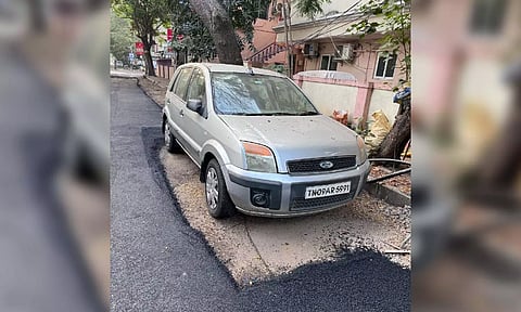 Relaid road without removing the parked car at Gandhi Nagar in Adyar