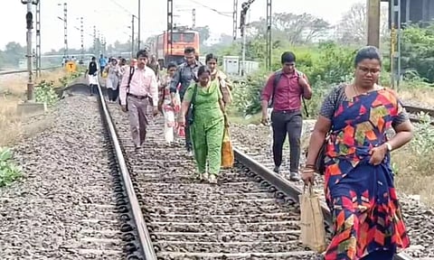 Passengers walked in railway track