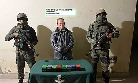 Arrested accused along with seized heroin in Assam Rifles custody (Photo/Assam Rifles). Image Credit: ANI
