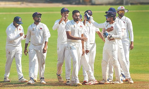 Mumbai players celebrate the wicket of Atharva Taide