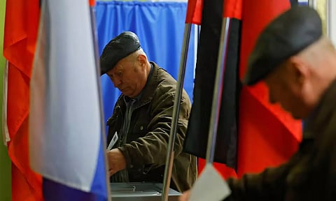 A man casts his ballot at a polling station during the Russia's presidential election, in the course of Russia-Ukraine conflict in Donetsk
