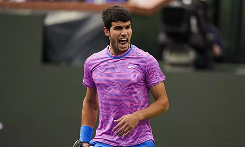 Carlos Alcaraz celebrates after a point against Jannik Sinner