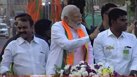 (L-R) Union Minister of State L Murugan; PM Modi; BJP state president K Annamalai&nbsp;