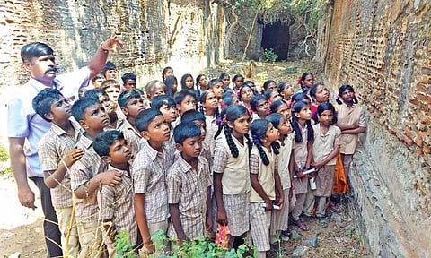 Students take a look at the inner portion of the ancient Sethupathi Palace at Tiruppullani on Tuesday