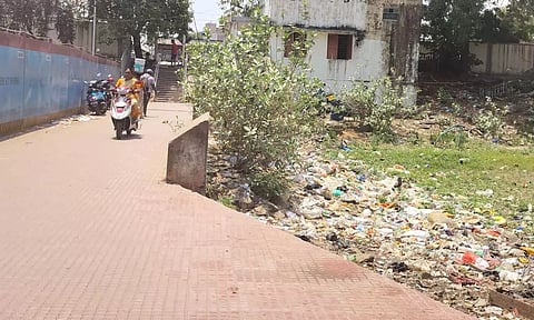 Garbage seen dumped along side of pathway leading to Villivakkam railway station
