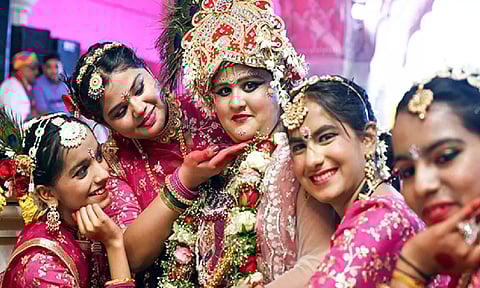Artists dressed in traditional attire pose for a picture during the Phagotsav (three-day Holi celebration), at Govinddevji temple in Jaipur on Thursday. (ANI)