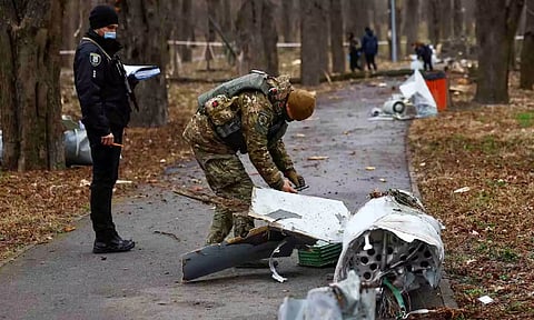 Police officers inspect a part of a Russian Kh-55 cruise missile, intercepted during a missile strike (Reuters)