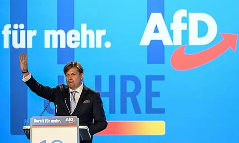 Maximilian Krah, Alternative for Germany (AfD) party member and member of the European Parliament of the Identity and Democracy (ID) group, waves his hand after a speech during the European election assembly 2023