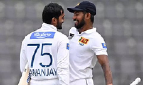 Sri Lanka’s Dhananjaya de Silva celebrates with Kamindu Mendis during the third day of the first Test cricket match against Bangladesh in Sylhet.
