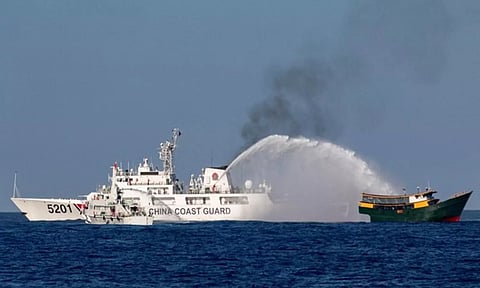 Chinese Coast Guard vessels fire water cannons towards a Philippine resupply vessel Unaizah (Reuters)
