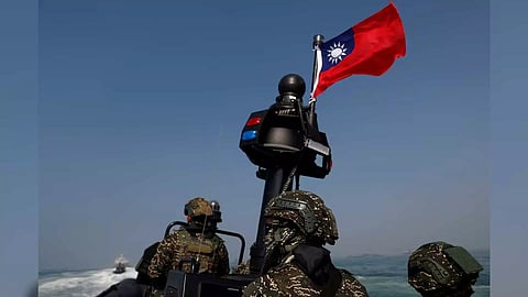 Members of Taiwan's Navy and media onboard a special operation boat with a Taiwanese flag fluttering over it during a drill (Photo/Reuters)