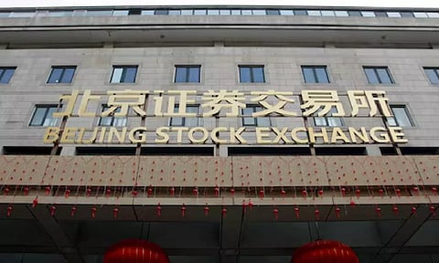 The sign of Beijing Stock Exchange is seen at its entrance during an organised media tour, in Beijing (Reuters)