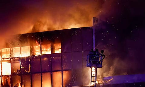 Rescuers work to extinguish fire at the burning Crocus City Hall concert venue following a shooting incident (Reuters)