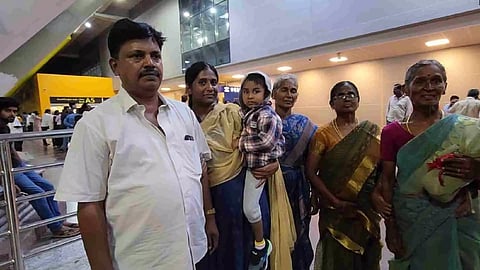 Abinaya Murugan carrying her nephew Visrith being received by their relatives at Chennai airport on Monday night