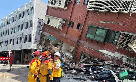 Firefighters work at the site of a collapsed building in Hualien (Reuters)