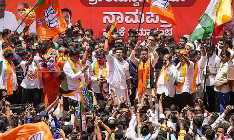 BJP candidate from Bengaluru South Tejasvi Surya with Union Minister Anurag Thakur and party leader R Ashoka during a rally before filing nomination ahead of the Lok Sabha elections, in Bengaluru (PTI)