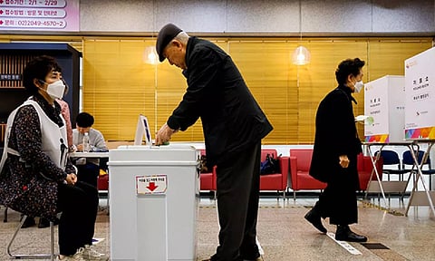 People vote at a polling station for parliamentary election in Seoul (ANI)