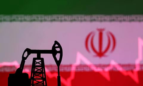 Iranian flag with stock graph and an oil pump jack miniature model are seen in this illustration (Reuters)&nbsp;