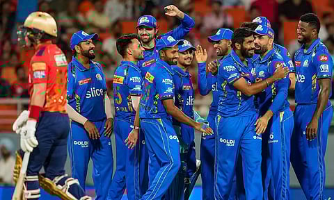 Mumbai Indians players celebrate after getting a wicket (PTI)