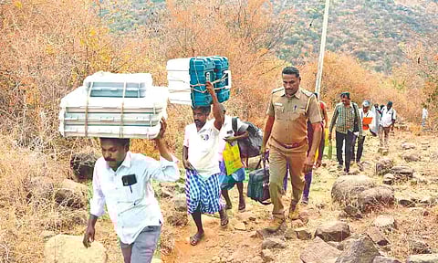 Polling materials carried as head load to hill villages in Namakkal