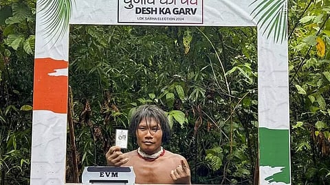 A voter from the Shompen tribal community poses for a photo after casting his vote for the first phase of Lok Sabha elections in Andaman and Nicobar Island. (Credit: PTI Photo)