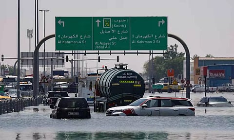 Cars are stranded in flood water on a blocked highway following heavy rainfall in Dubai (Reuters)